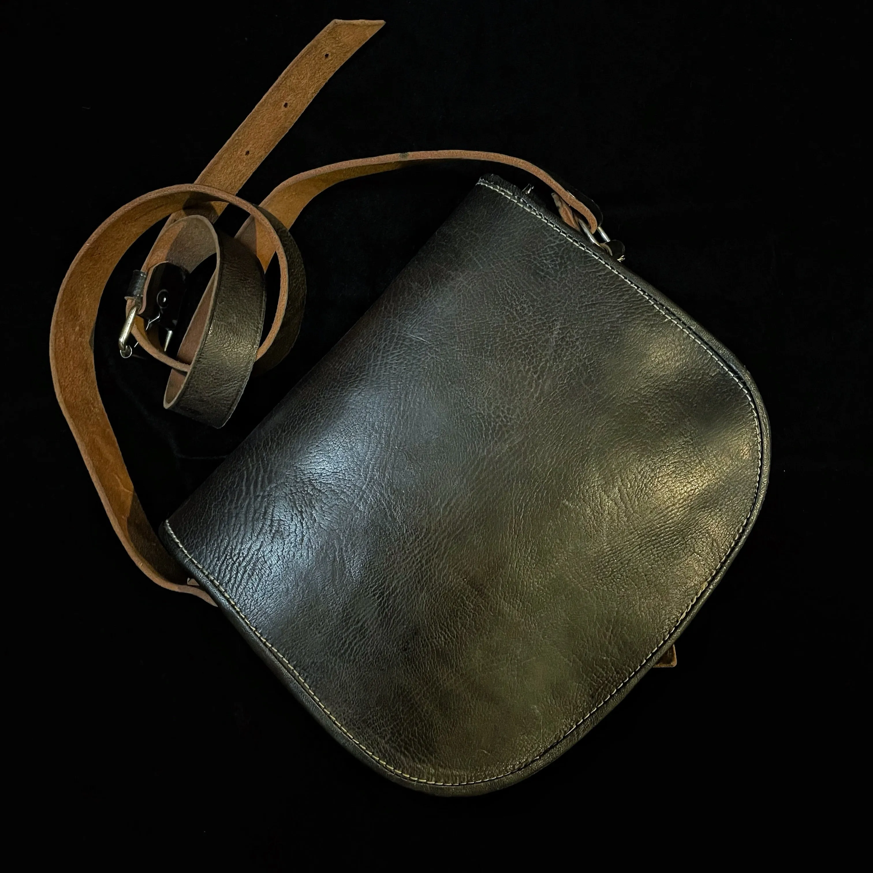 A HAND CRAFTED WESTERN STYLE STUDDED BAG WITH BLUE JEWEL