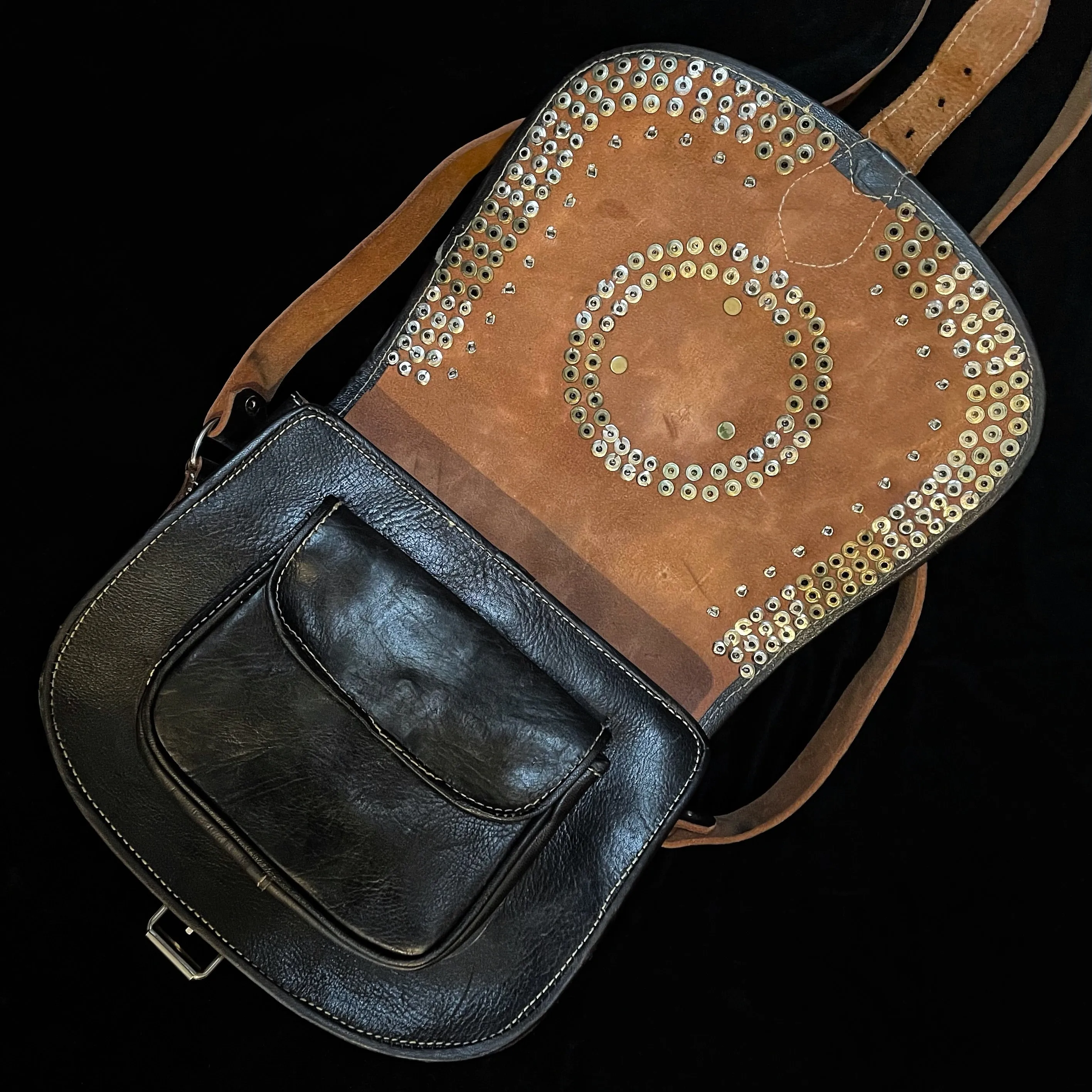 A HAND CRAFTED WESTERN STYLE STUDDED BAG WITH BLUE JEWEL