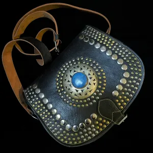 A HAND CRAFTED WESTERN STYLE STUDDED BAG WITH BLUE JEWEL