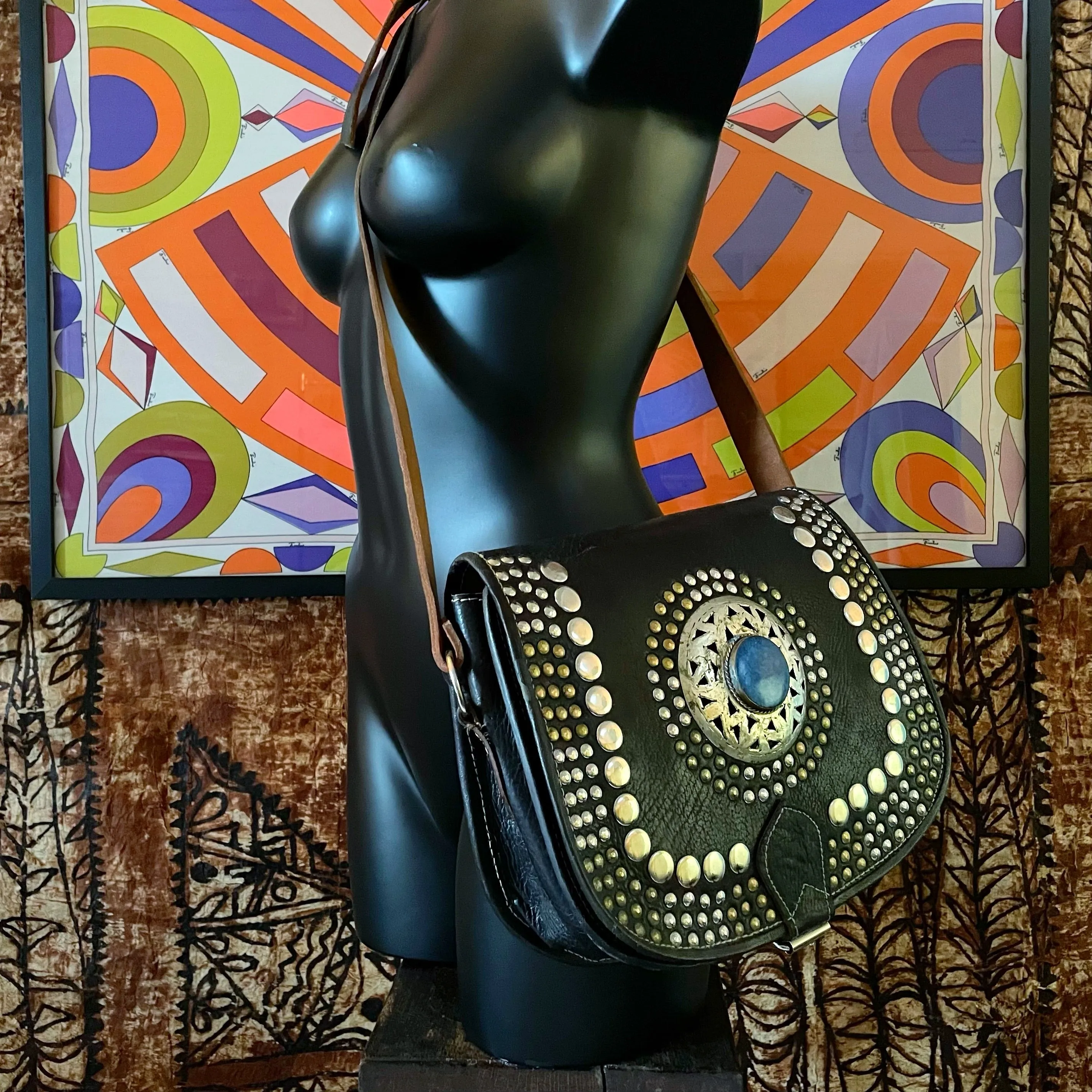 A HAND CRAFTED WESTERN STYLE STUDDED BAG WITH BLUE JEWEL