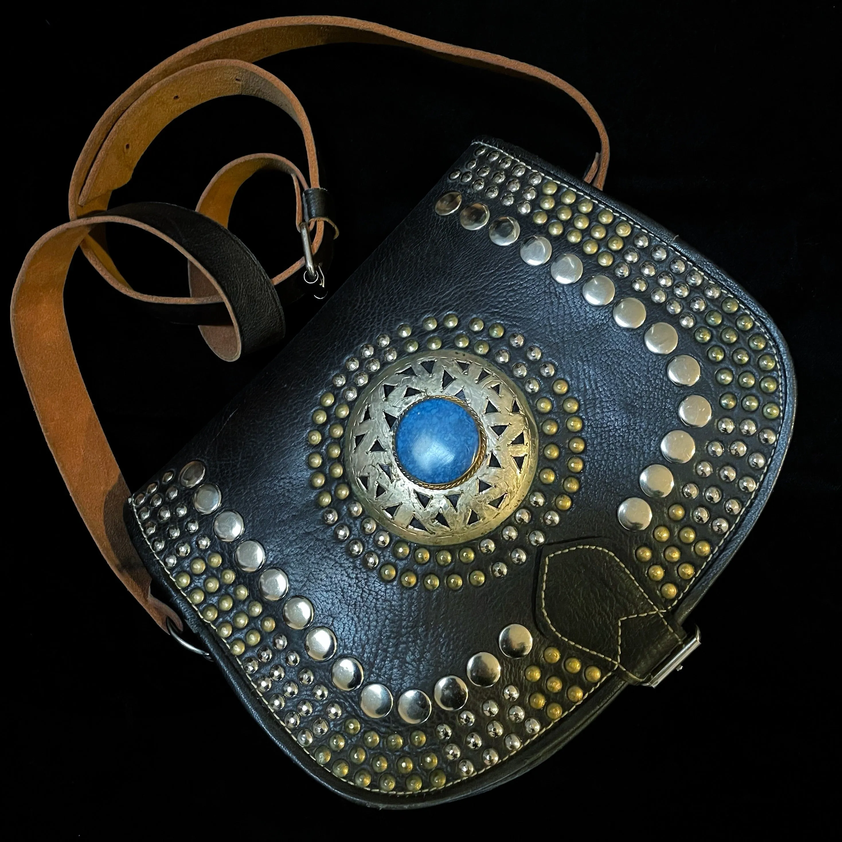 A HAND CRAFTED WESTERN STYLE STUDDED BAG WITH BLUE JEWEL