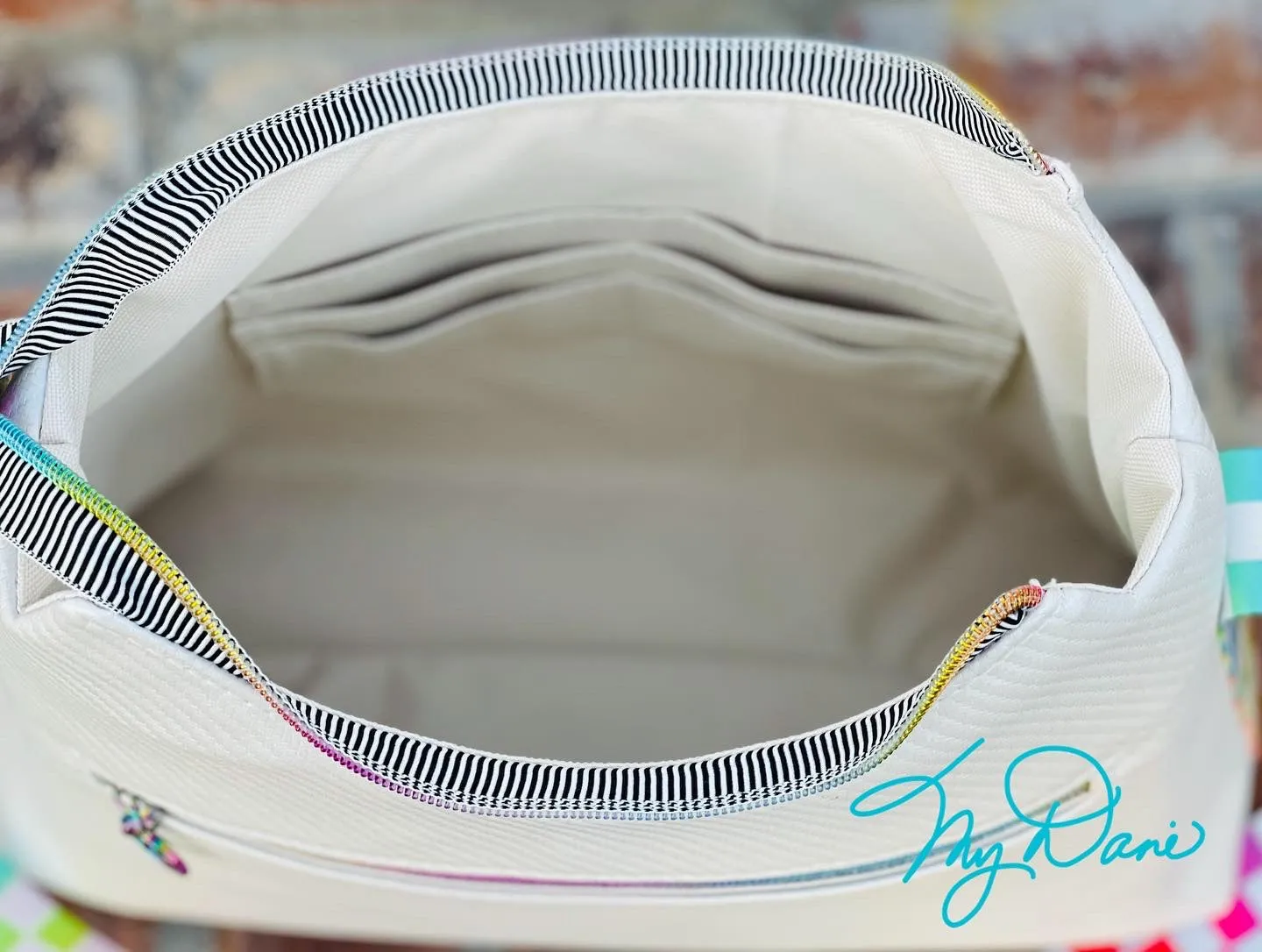 The Beanie Baguette Handbag in textured off white w/racing stripes webbing