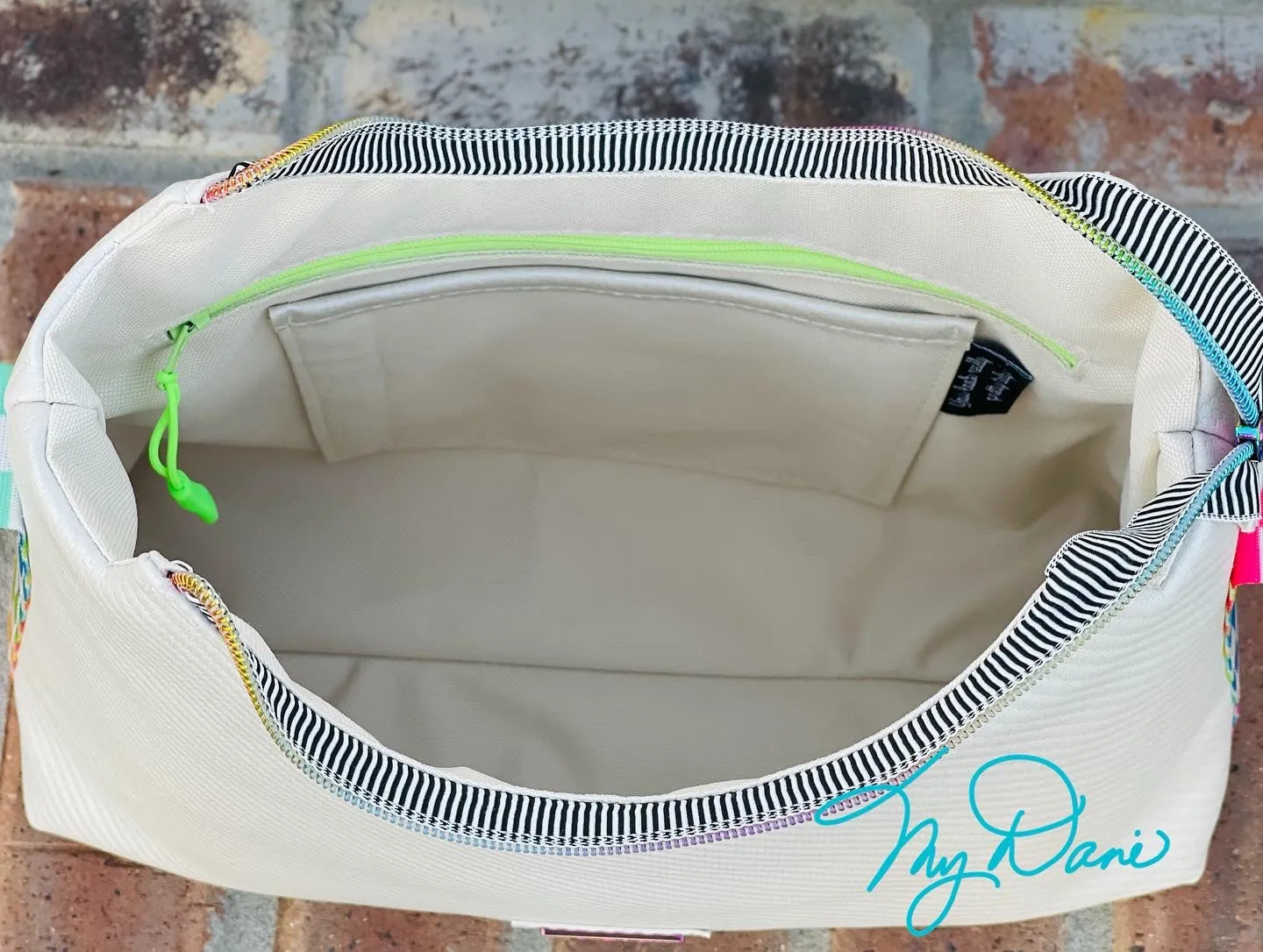 The Beanie Baguette Handbag in textured off white w/racing stripes webbing